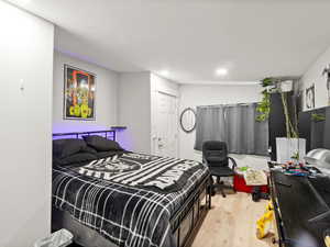 Bedroom with wood-type flooring