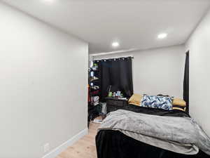 Bedroom with hardwood / wood-style floors