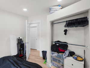 Bedroom featuring light wood-type flooring and a closet