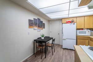 Kitchen featuring white appliances and dark hardwood / wood-style floors