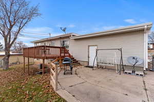 Back of property featuring a patio area and a deck