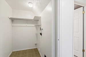 Laundry area featuring a textured ceiling