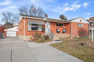 View of front of house with a front yard, and a 2 garage