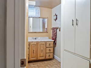 Bathroom featuring vanity plus built in cabinets and drawers