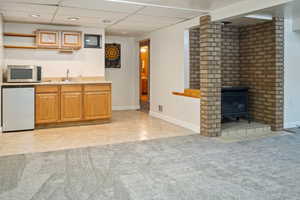 Basement wet bar with mini refrigerator. family room.