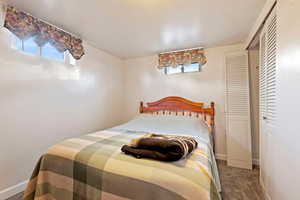 Carpeted bedroom with a closet