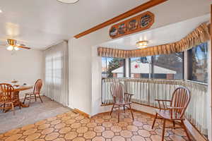 Kitchen area with a eating nook plus additional space for larger table.  with ceiling fan