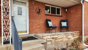 Doorway to property with covered porch