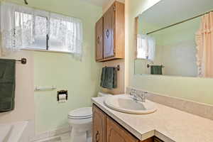 Full bathroom featuring tile patterned flooring, vanity, toilet, and shower / bathtub combination with curtain