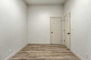 Unfurnished room with light hardwood / wood-style flooring