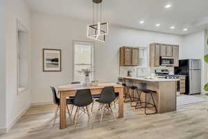 Dining area featuring light wood-type flooring and sink