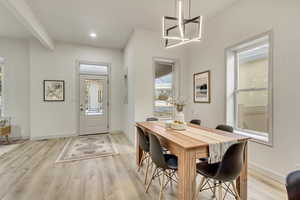 Dining room featuring a chandelier and light hardwood / wood-style flooring