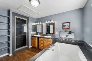 Bathroom with hardwood / wood-style floors, vanity, and shower with separate bathtub