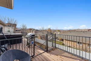 Wooden deck featuring a grill