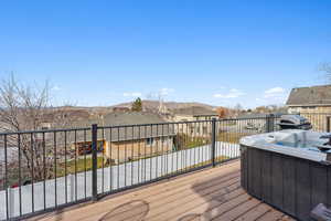 Wooden terrace featuring a hot tub