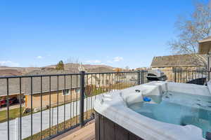 Wooden terrace with a mountain view, grilling area, and a hot tub