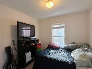 Bedroom featuring carpet floors and a textured ceiling