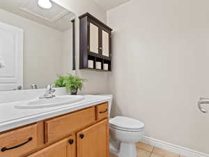 Bathroom with tile patterned flooring, vanity, and toilet