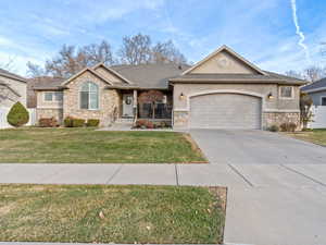 Ranch-style home with a front lawn and a garage