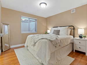 Bedroom with light hardwood / wood-style flooring