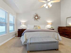 Carpeted bedroom featuring ceiling fan