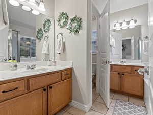 Bathroom with tile patterned floors, vanity, and toilet