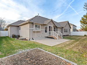 Back of house featuring a patio area and a yard