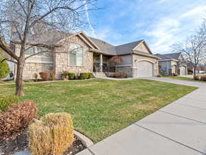 View of front of property with a front lawn and a garage