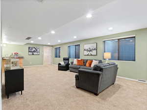 Carpeted living room featuring sink