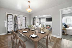 Dining space with a textured ceiling and dark hardwood / wood-style floors