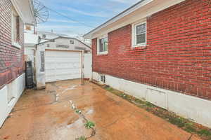 View of side of property featuring a garage and an outdoor structure