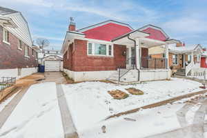 Bungalow-style house with an outbuilding and a garage