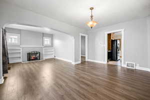 Unfurnished living room featuring hardwood / wood-style floors and a textured ceiling