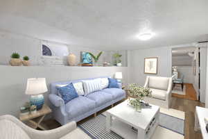 Living room featuring hardwood / wood-style floors and a textured ceiling