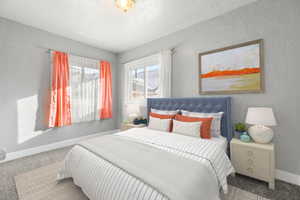 Carpeted bedroom featuring a textured ceiling