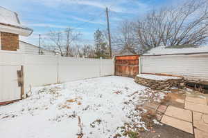 Snowy yard with a storage unit