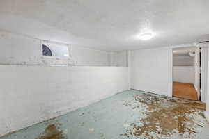 Basement with a textured ceiling