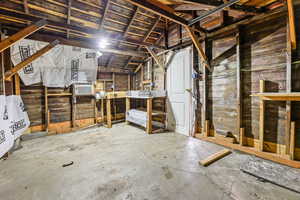 Unfinished attic featuring cooling unit