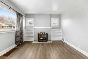 Unfurnished living room with hardwood / wood-style floors