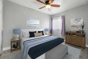 Bedroom featuring ceiling fan, light colored carpet, and a textured ceiling