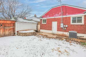 Snow covered property with cooling unit