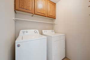 Clothes washing area with cabinets and washing machine and clothes dryer