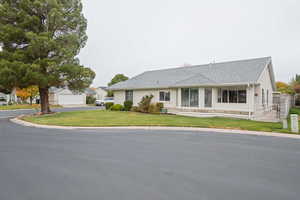 Single story home with a front yard and a garage