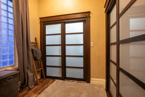 Doorway to outside featuring dark hardwood / wood-style flooring