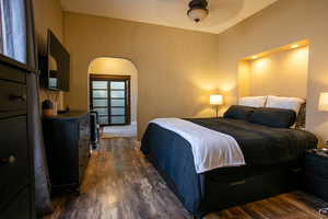 Bedroom featuring ceiling fan and dark hardwood / wood-style flooring