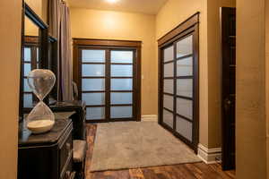 Doorway featuring dark hardwood / wood-style flooring