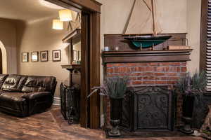 Living room featuring a fireplace and wood-type flooring