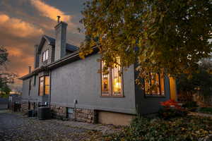 Property exterior at dusk featuring cooling unit