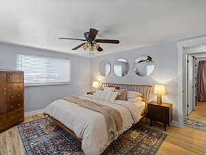 Bedroom with light hardwood / wood-style flooring and ceiling fan