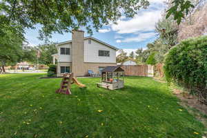 Back of house featuring a yard